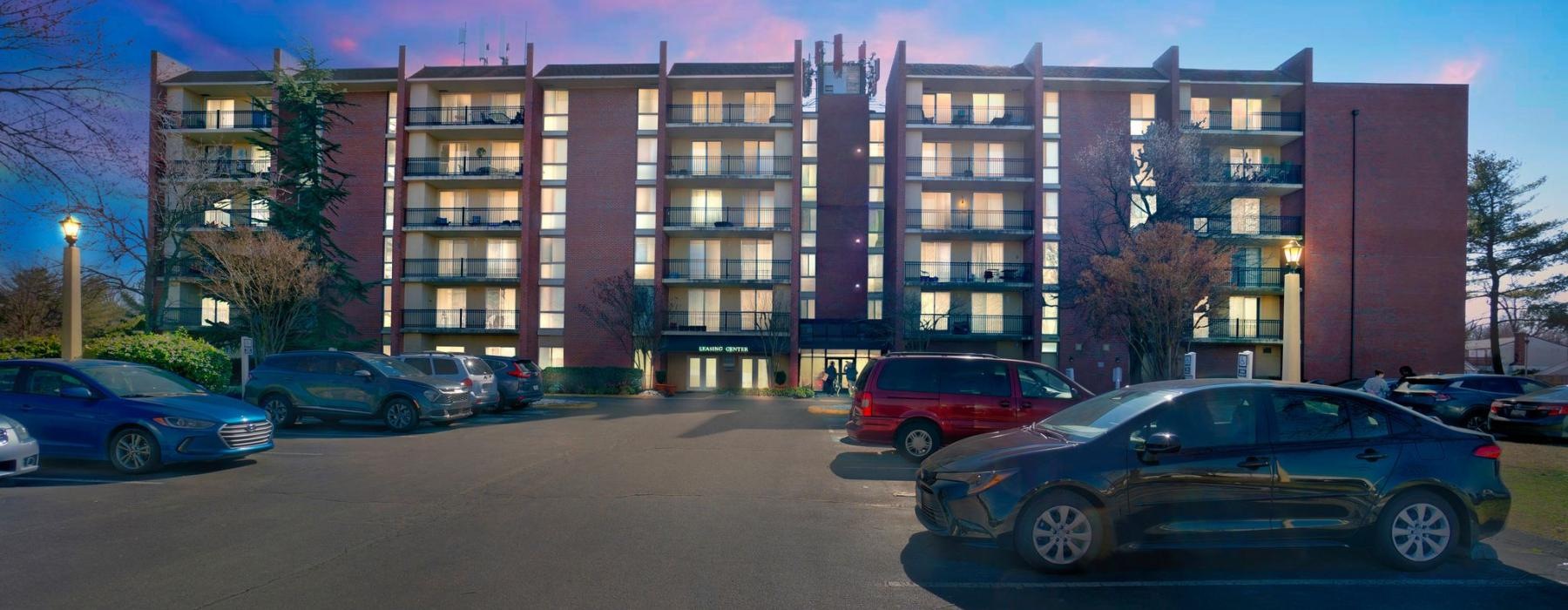 a parking lot with cars and a building in the background